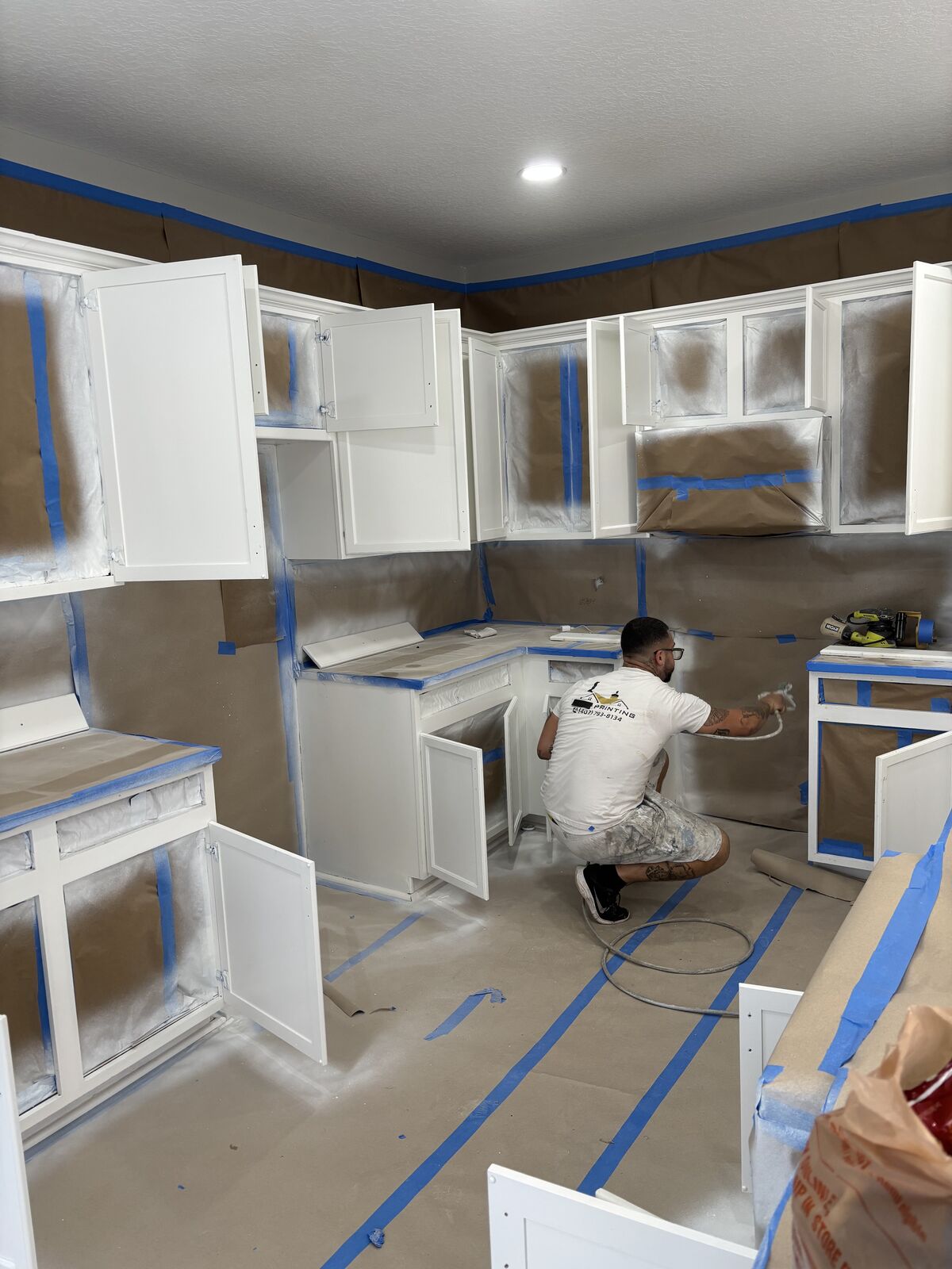 DJJ team spraying kitchen cabinets